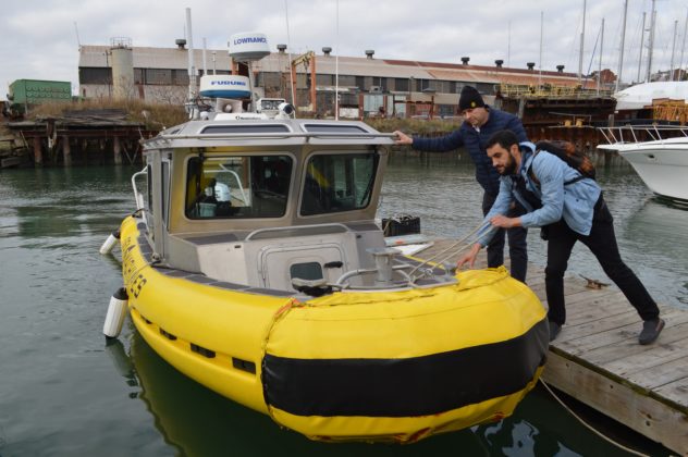 Michael Johnson and Mohamed Saad Ibn Seddik preparing one of Sea Machines' autonomous boats.